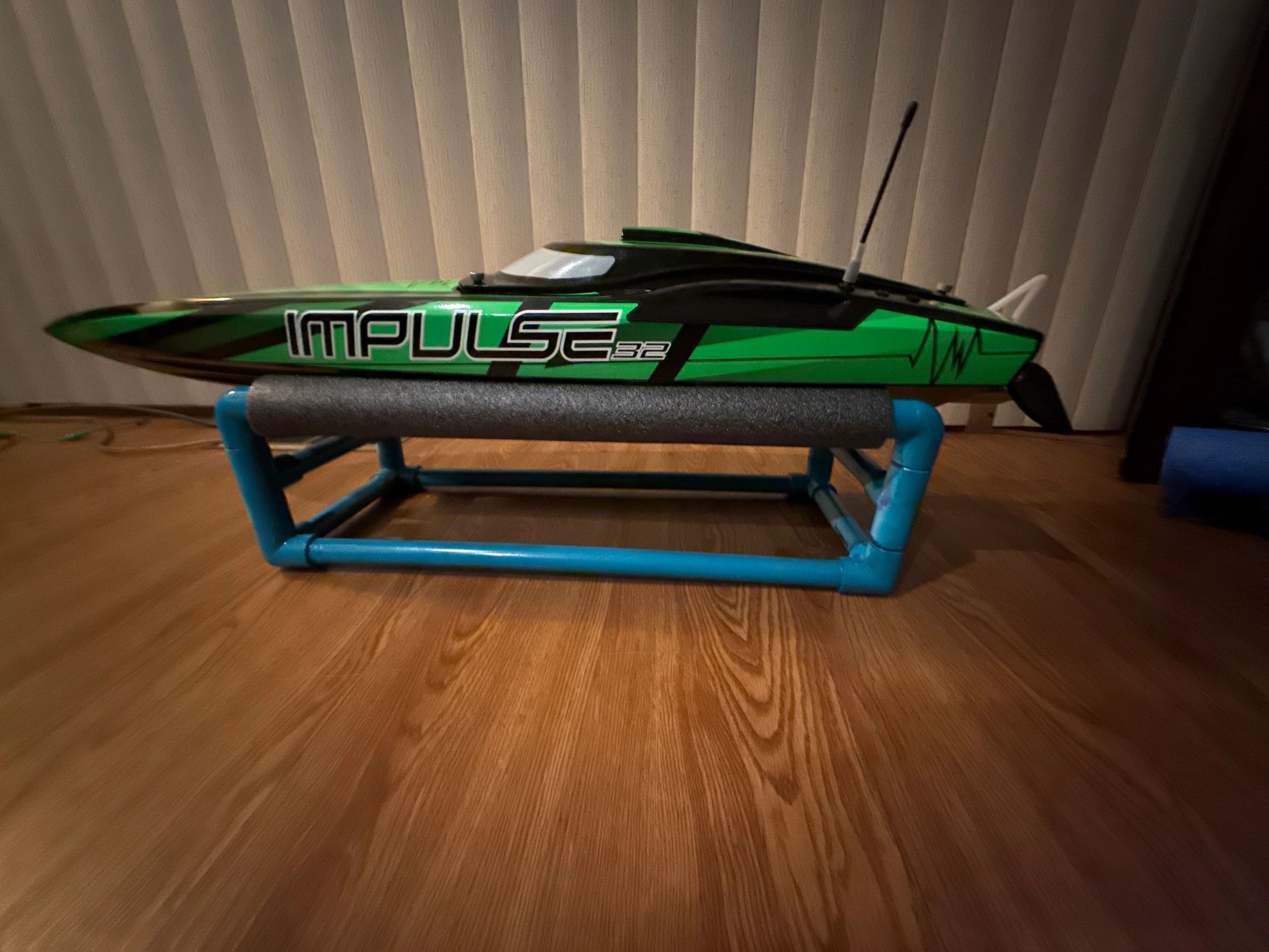 RC boat racing across the water with dramatic spray